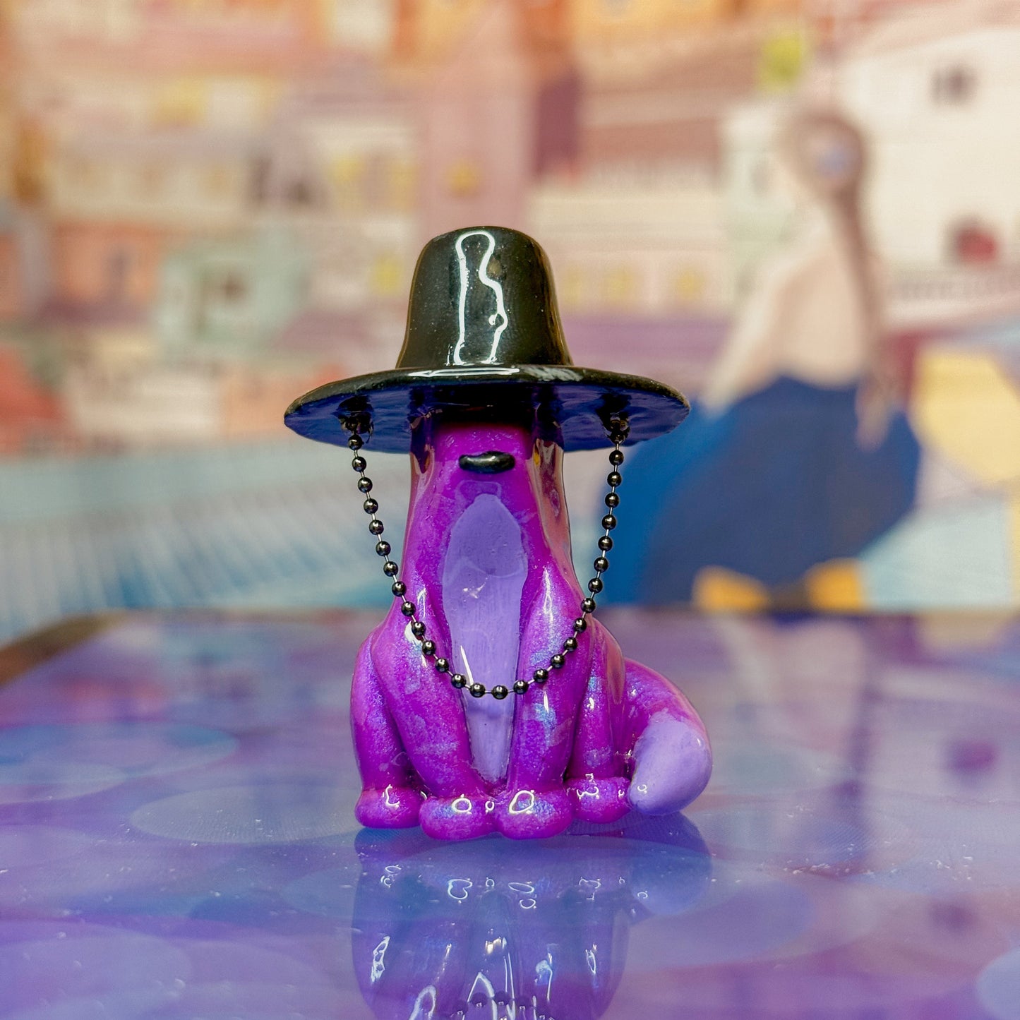 Purple fox figurine wearing a traditional korean gat on a reflective surface with a colorful abstract background